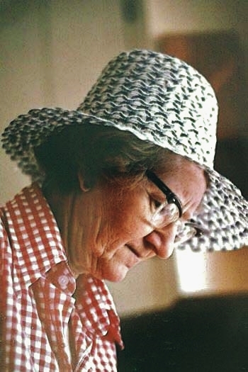 One of my German cousins just sent me this picture. It was taken in the summer of 1981. Mom has just come in from the garden. (I know this because of that distinctive hat; she wore it for years every time she set foot outside between April and October!) She could be shelling peas, or hulling strawberries; that look of concentration and her slight frown is utterly typical. My family tells me I look just the same; our faces share a rather sombre cast which does not necessarily reflect our actually happy mood!