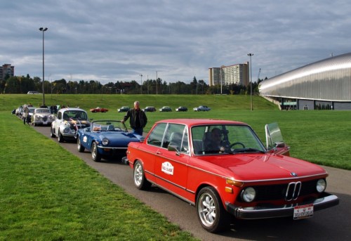 "Start your engines..." Here we are getting ready to set off on our rally. That's us, the little blue Spitfire hiding between the Beamer and the Bug.