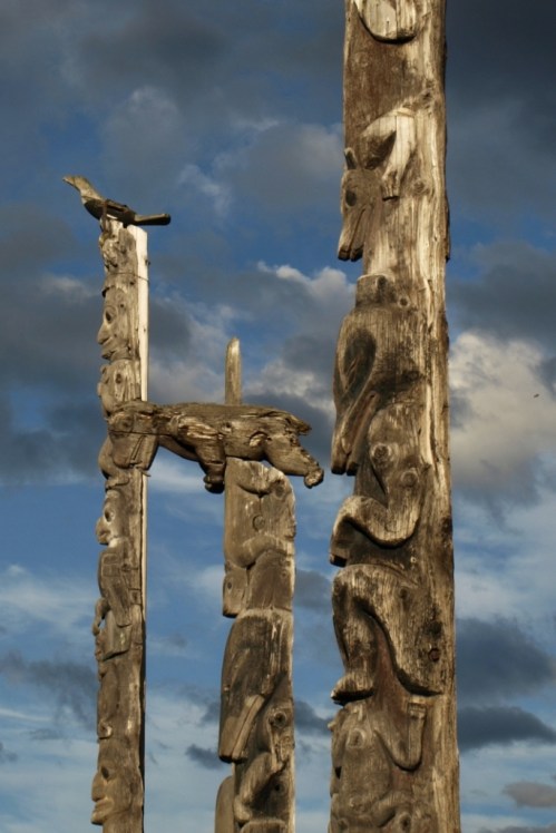 Totem poles near Kitwanga, B.C. These are memorial poles erected over the graves of band chiefs. The figures depict clan memberships and significant connections of the people they memorialize.